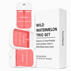 Touchland Wild Watermelon spray in use with visible mist demonstrating quick coverage and fast drying