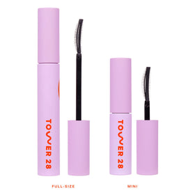 Tower 28 mini mascara next to common travel items for size and portability