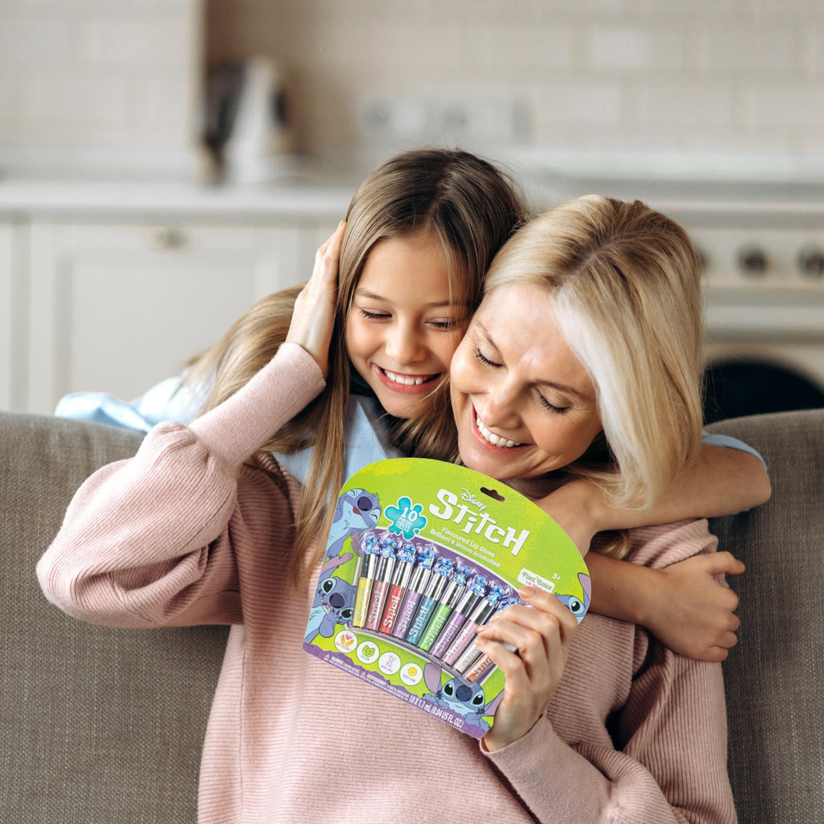 Townley Girl gloss beside a child’s hand to show compact size and portability