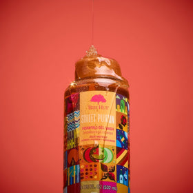 Tree Hut Sweet Punkin bottle beside a water glass for size comparison and travel awareness