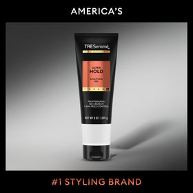 Stylist applying TRESemmé gel to damp hair for frizz control