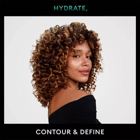 TRESemmé mousse being scrunched into damp hair for defined curls