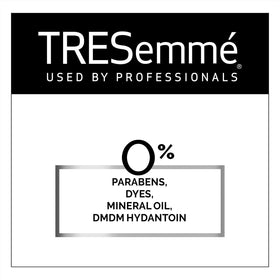 TRESemmé bottles next to passport and phone showing carry-on readiness