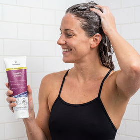 TRIHARD poolside use lifestyle image showing post-swim hair care