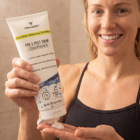 Swimmer poolside using TRIHARD conditioner for pre and post swim care