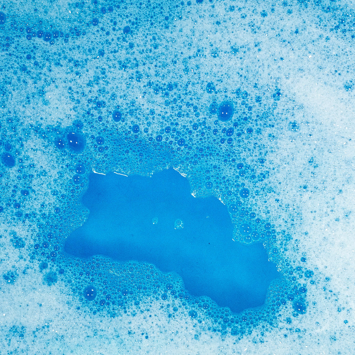 Tub Works pouch beside a rubber duck showing scale and convenient single‑use size
