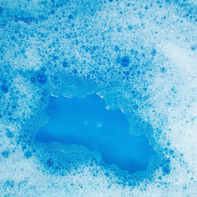 Tub Works pouch beside a rubber duck showing scale and convenient single‑use size