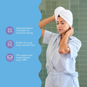 Turbie Twist towel beside hand showing scale and lightweight ease-of-use benefit