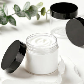 TUZAZO jar being filled with lotion using spatula for tidy product transfer advantage