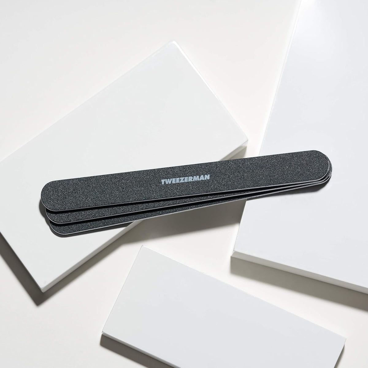 Tweezerman file held in hand to show 7-inch scale and improved leverage