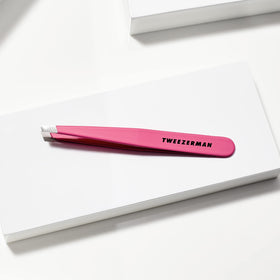 Tweezerman held in hand to show scale and comfortable ergonomic size