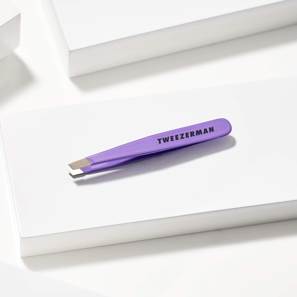 Tweezerman brushed metal finish detail highlighting durable quality benefit