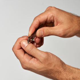 Tweezerman angled blade close-up highlighting sharp edge for clean trims