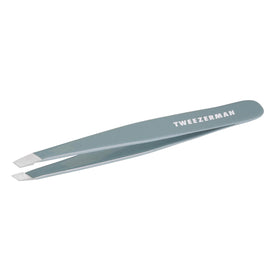 Tweezerman mist blue slant tweezer front view showing ergonomic shape and precise control