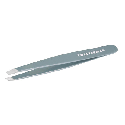 Tweezerman mist blue slant tweezer front view showing ergonomic shape and precise control