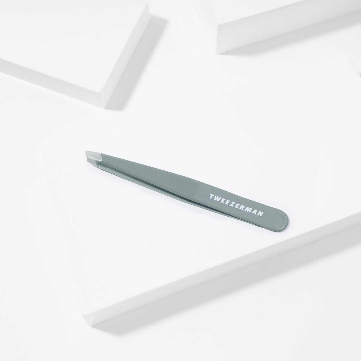Tweezerman product packaging and label highlighting professional stainless steel quality