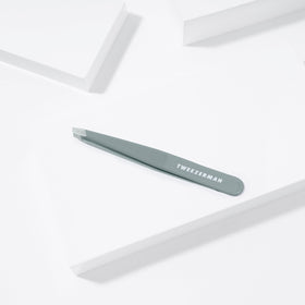 Tweezerman product packaging and label highlighting professional stainless steel quality