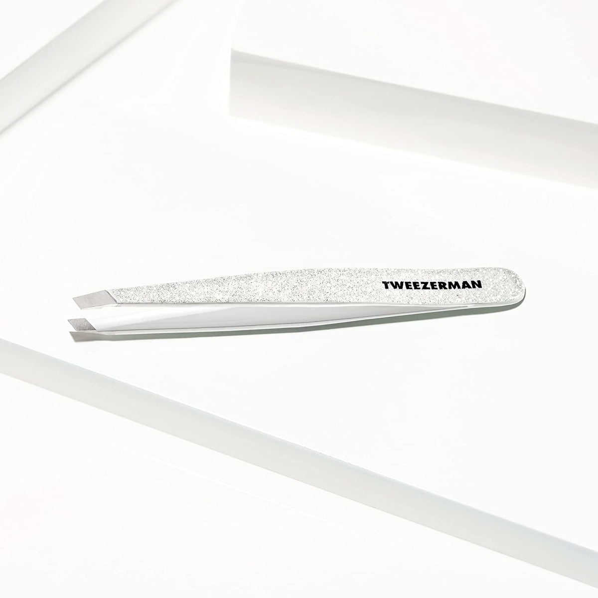 Tweezerman tweezer held in hand showing size and ergonomic control