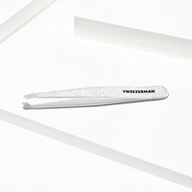 Tweezerman tweezer held in hand showing size and ergonomic control
