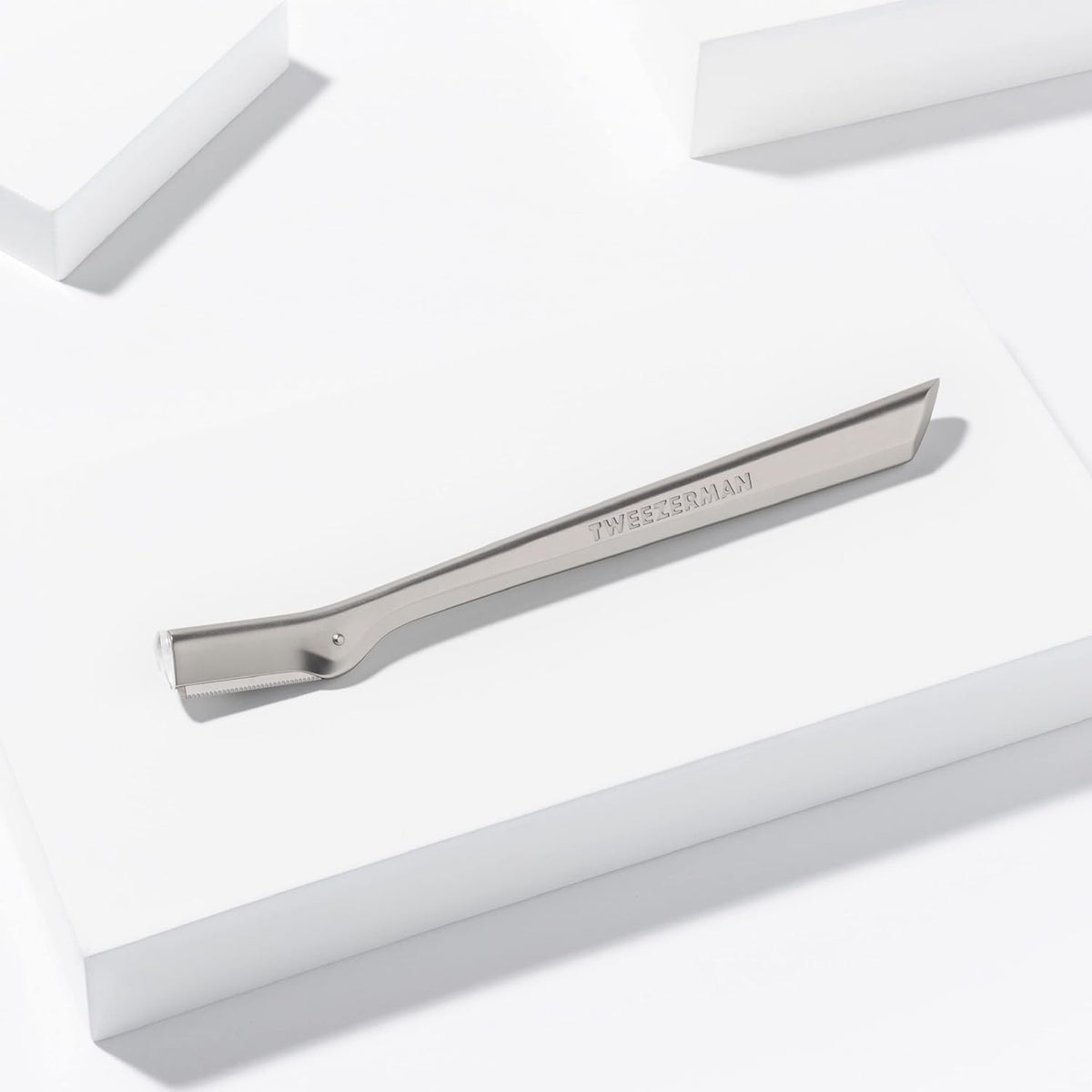 Tweezerman three replacement blades and safety cap displayed for safe storage and easy swapping