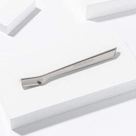 Tweezerman three replacement blades and safety cap displayed for safe storage and easy swapping