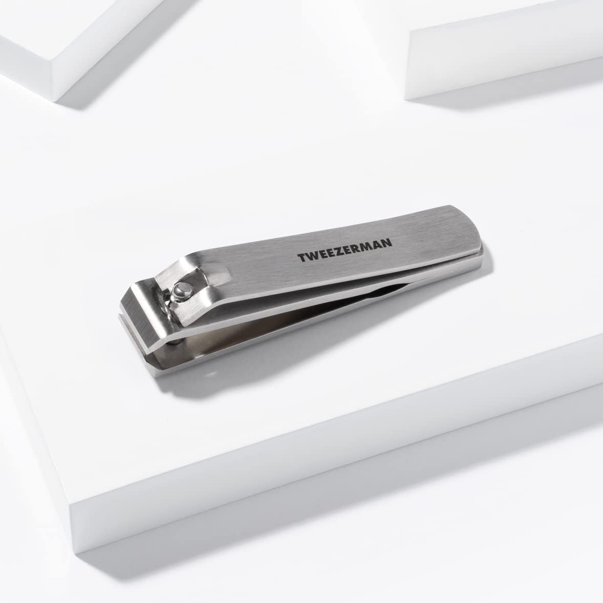 Tweezerman clipper being cleaned with alcohol wipe for quick sanitization