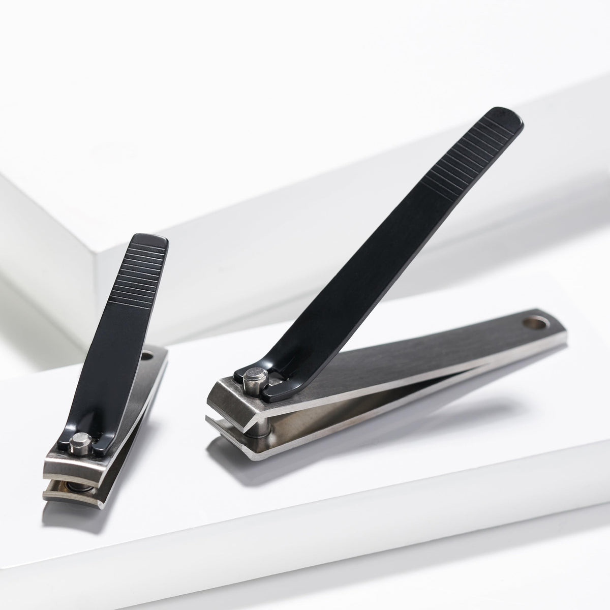 Tweezerman clippers beside a coin for size comparison and travel-friendly portability