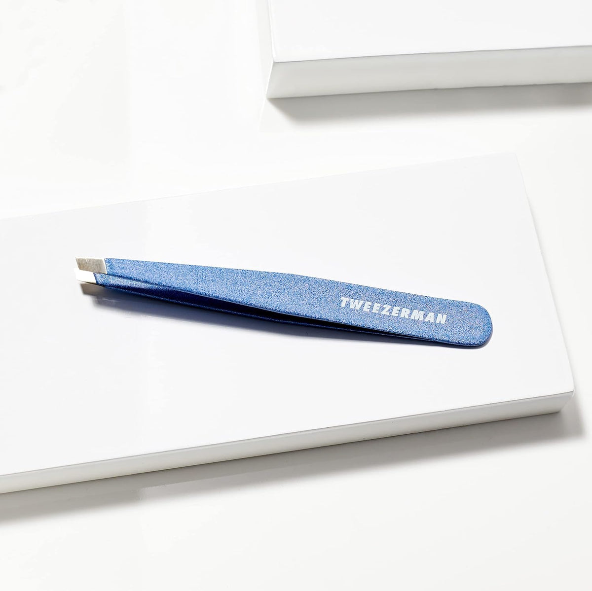 Tweezerman inside a makeup pouch showing travel-friendly size and quick-access convenience