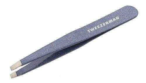 Tweezerman placed on warm washcloth illustrating prep routine for gentler hair removal