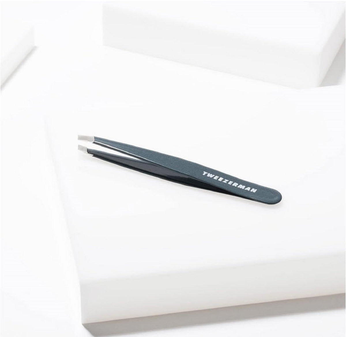 Tweezerman tweezer and alcohol wipe demonstrating simple tip cleaning for hygiene