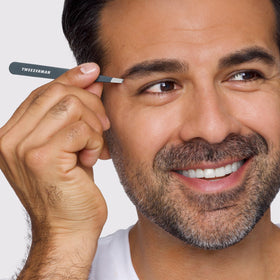 Tweezerman close-up of hand-filed slanted tip capturing fine hairs with precise alignment