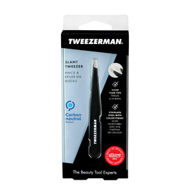 Tweezerman tweezer next to ruler for scale showing compact travel-ready size advantage