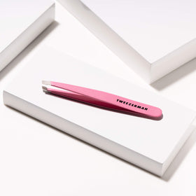 Tweezerman tea rose tweezer removing a single hair to illustrate precise root extraction