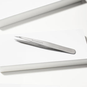 Tweezerman tweezer in use removing a fine hair to demonstrate clean extraction benefit
