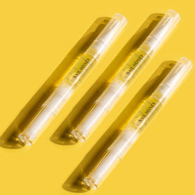 Twinkled T 2ml pen beside coin to show compact travel-friendly size