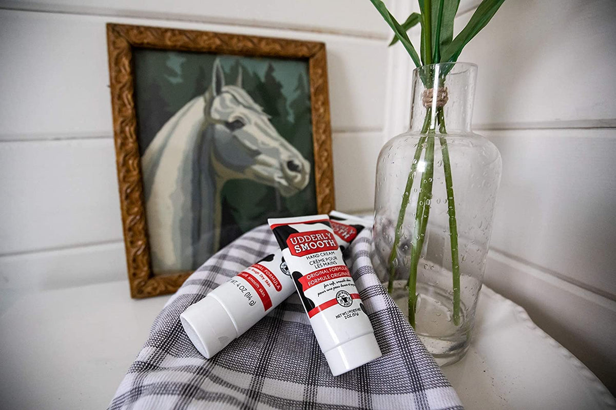 Open Udderly Smooth tube with cream dispensed highlighting easy-squeeze cap and control
