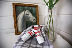 Open Udderly Smooth tube with cream dispensed highlighting easy-squeeze cap and control
