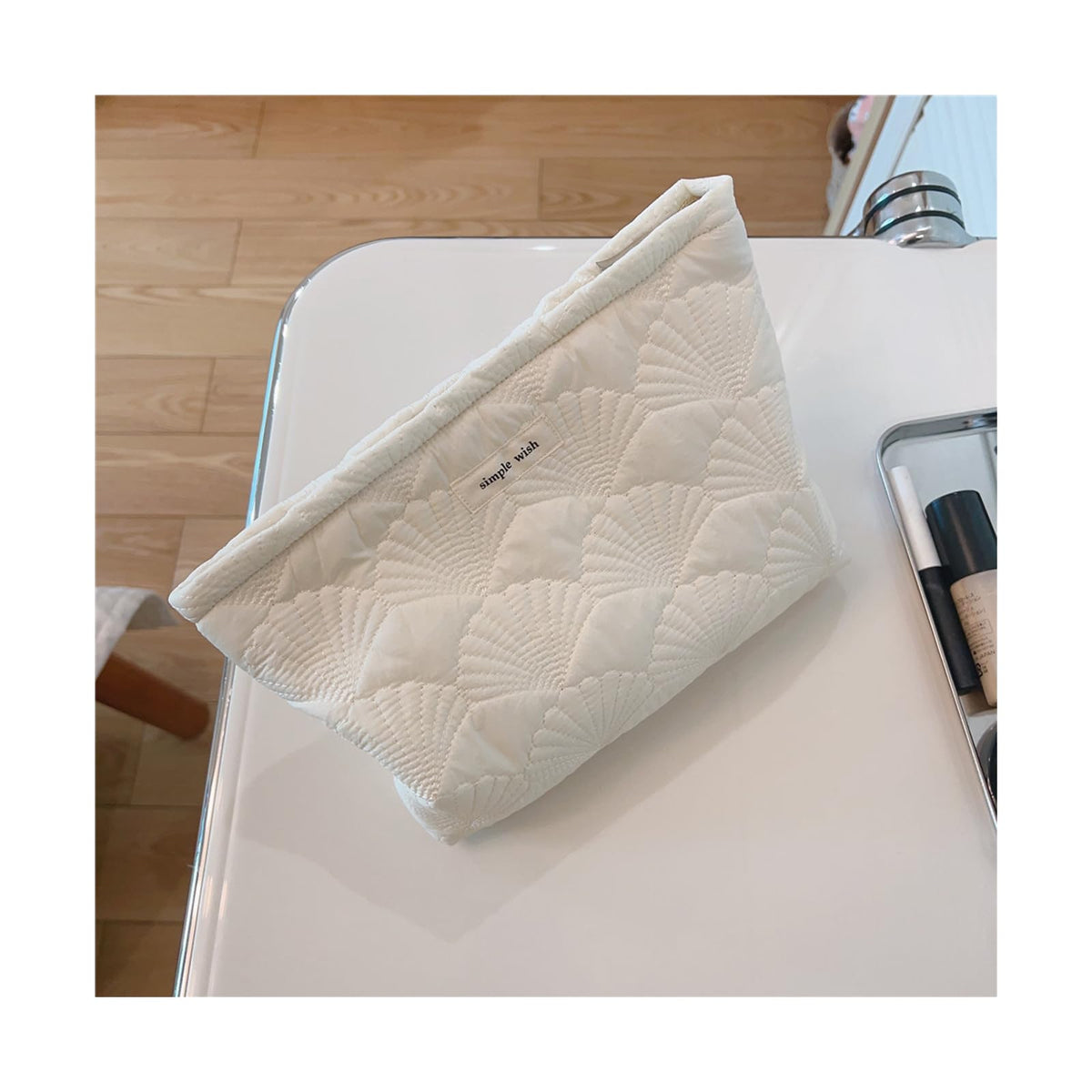 uekeboag pouch next to handbag illustrates compact size and convenient carry