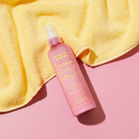 Umberto Giannini bottle on bathroom shelf for travel-ready convenience benefit