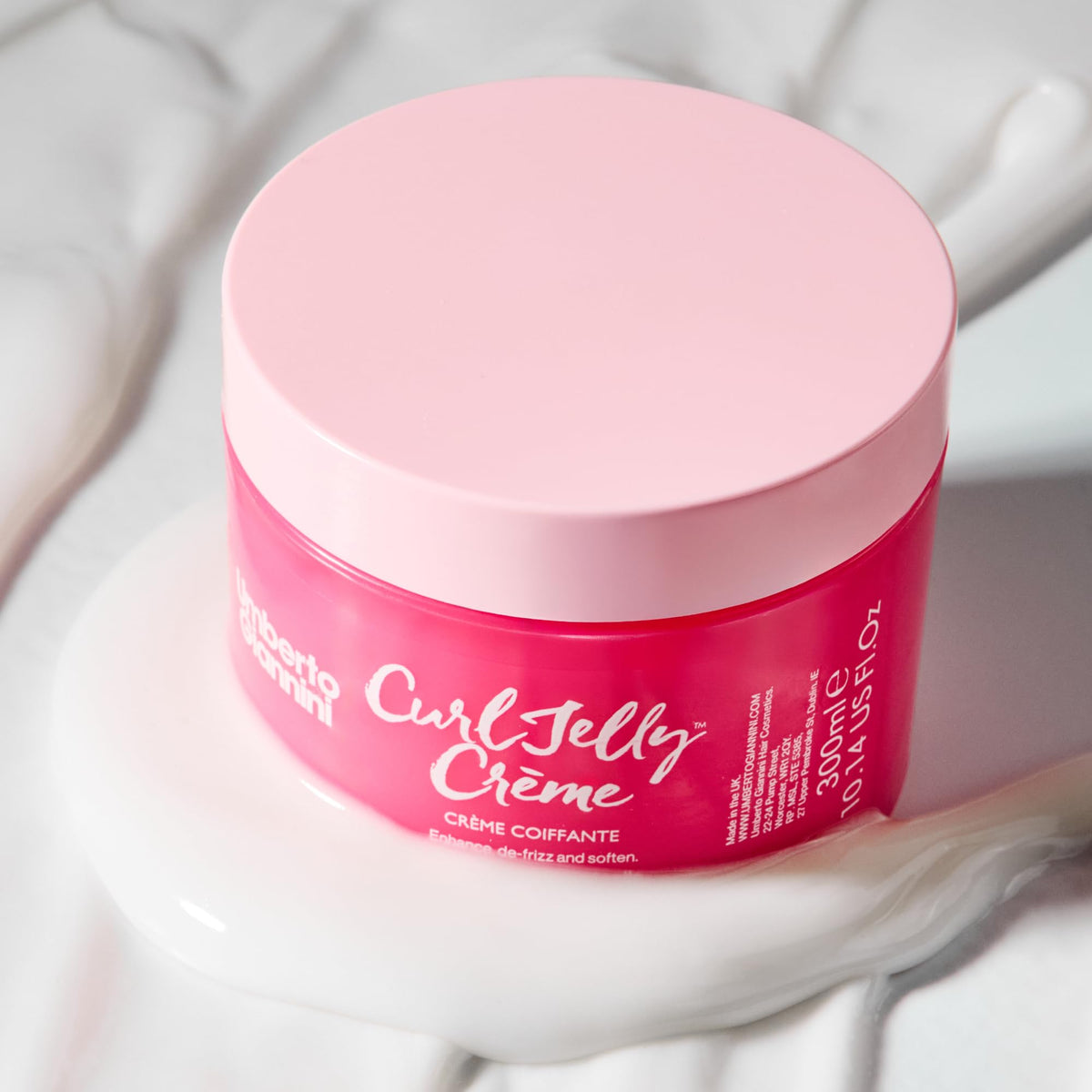 Umberto Giannini styling crème on palms ready for application