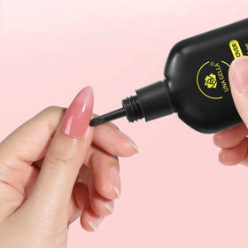 UNA GELLA product in use removing a press-on nail tip safely at home
