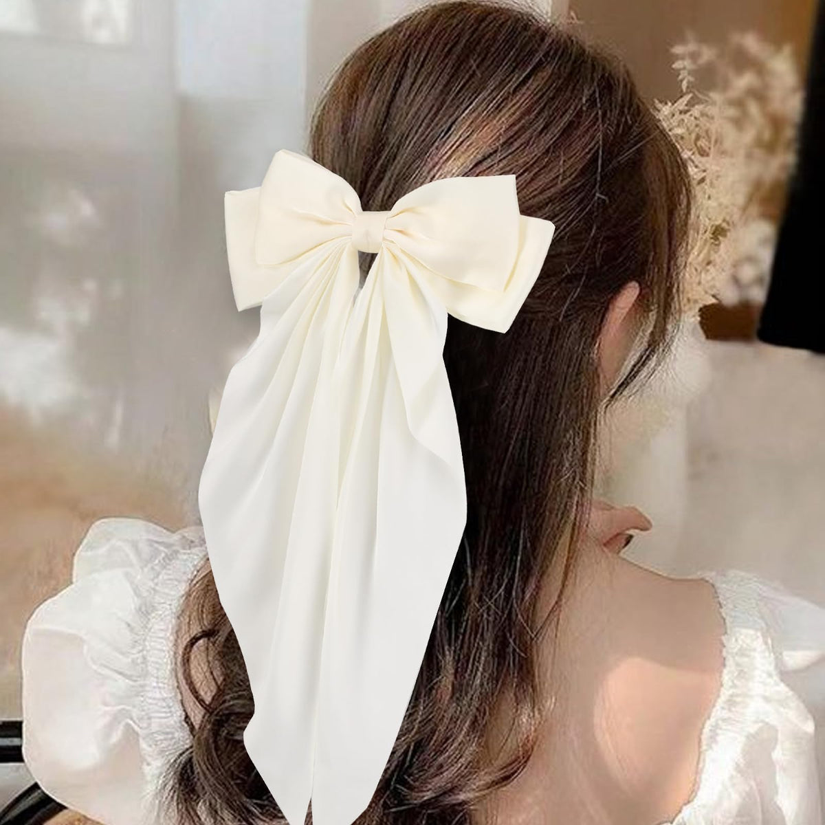 Unbednigt bow worn in half-up hairstyle demonstrating added volume and refined style