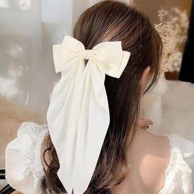 Unbednigt bow worn in half-up hairstyle demonstrating added volume and refined style
