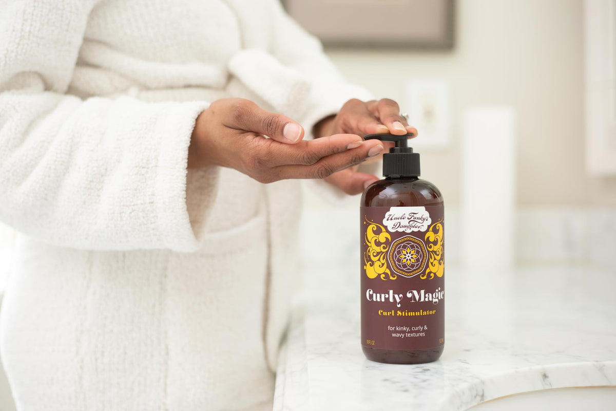 Applying Uncle Funky's Daughter Curly Magic to damp curls demonstrating ease of styling