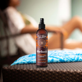 Uncle Funky's Daughter being applied to scalp demonstrating targeted odor neutralizing benefit