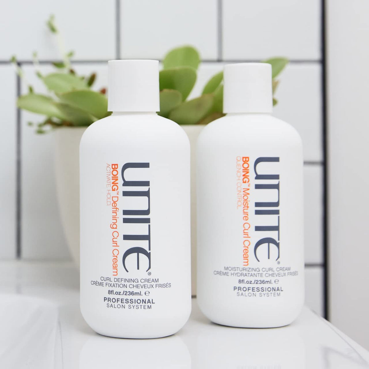 UNITE BOING held in hand to show 8 fl oz size and portability