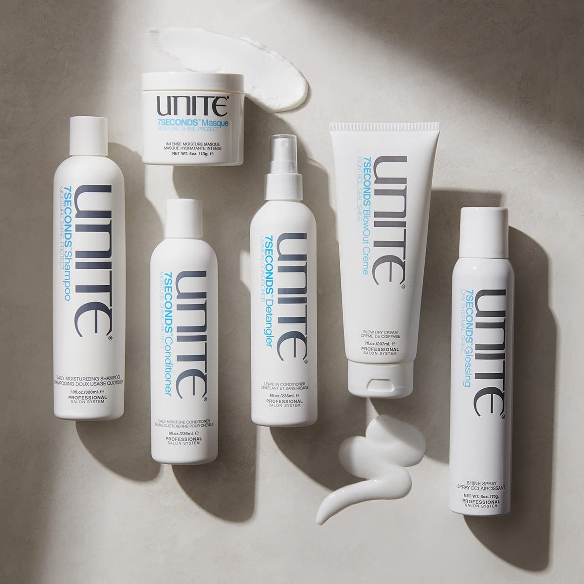 UNITE Hair 32 oz bottle beside hand to show size and value benefit