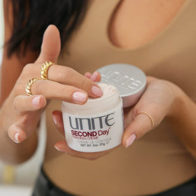 UNITE SECOND Day 2 oz in hand showing scale and travel-friendly convenience