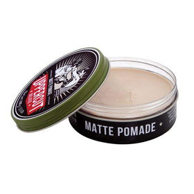 UPPERCUT DELUXE pomade in hand demonstrating lightweight feel and controllable hold