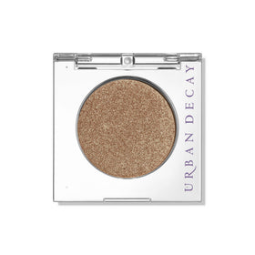 Urban Decay Half Baked front pan showing golden shimmer and secure packaging benefit